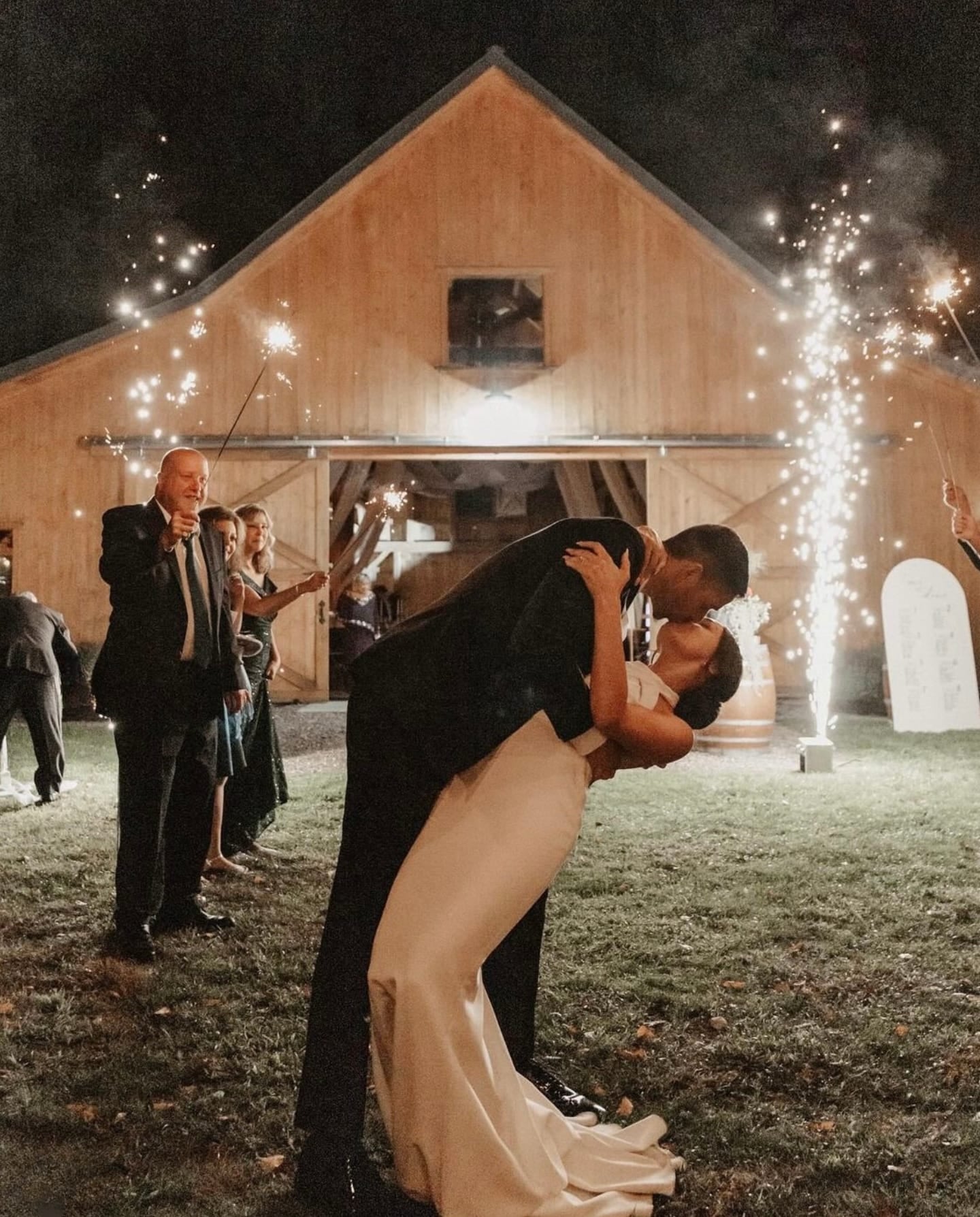 Guests holding sparklers on the dance floor during a Liquid Sound wedding production